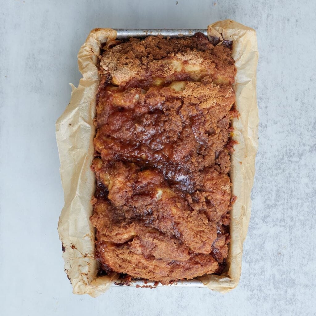 Freshly baked Sourdough Peach Pull-Apart Bread in a parchment lined loaf pan.