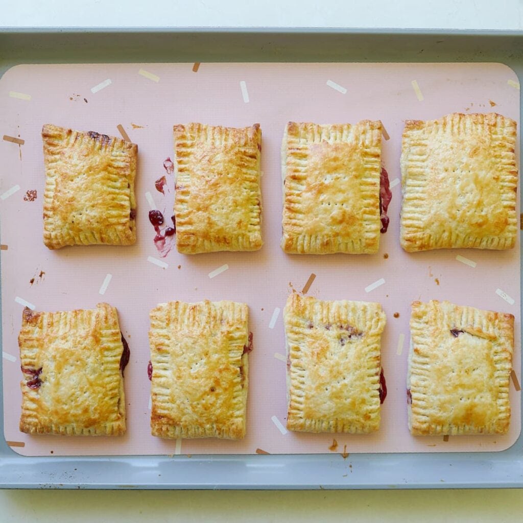 Freshly baked Sourdough Pop Tarts on a sheet pan lined with a silicone baking mat.