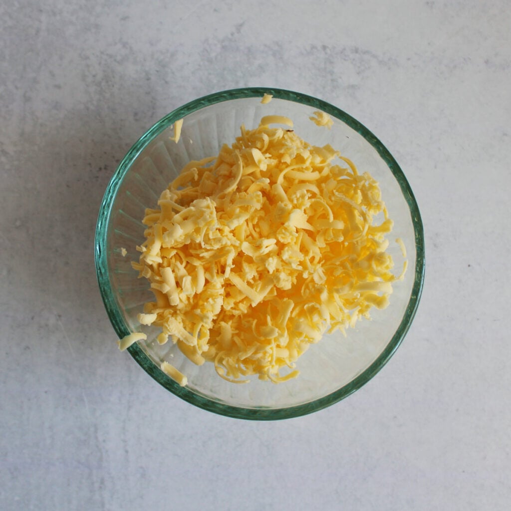Frozen butter shredded in a small bowl.