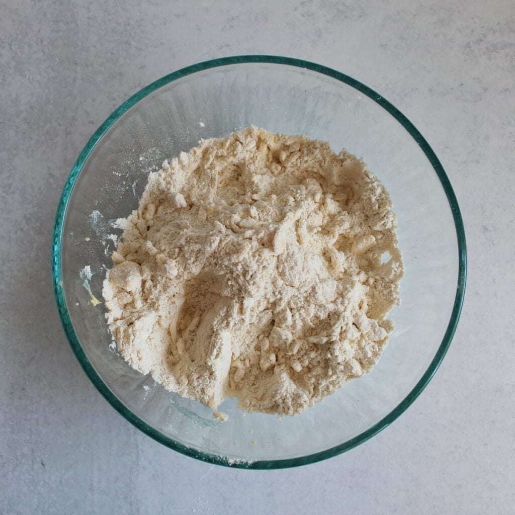 Dry ingredients for Chocolate Chip Sourdough Scones mixed with grated frozen butter.