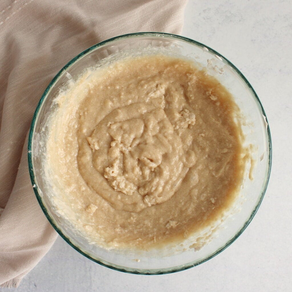 Batter for Chocolate Chip Sourdough Muffins mixed together in a clear bowl.