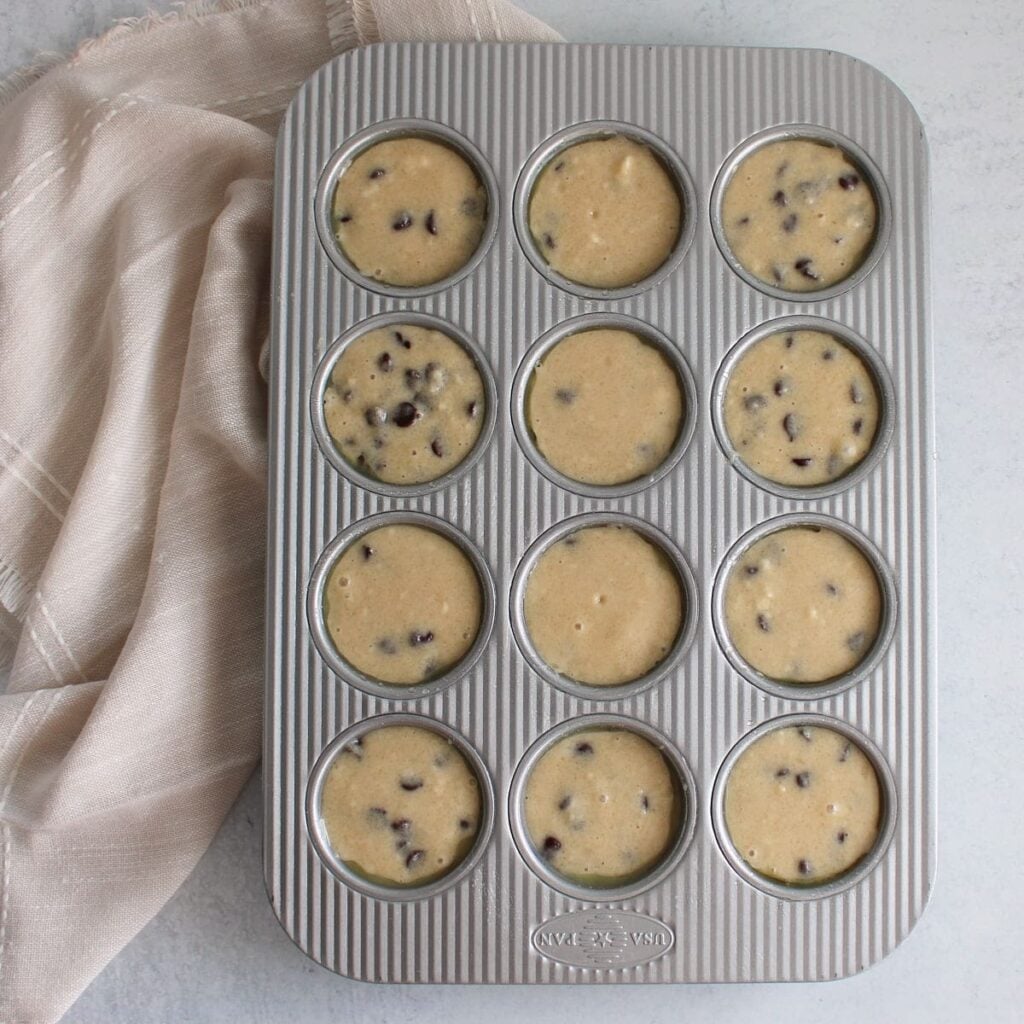 Chocolate Chip Sourdough Muffins batter in a muffin pan before baking.