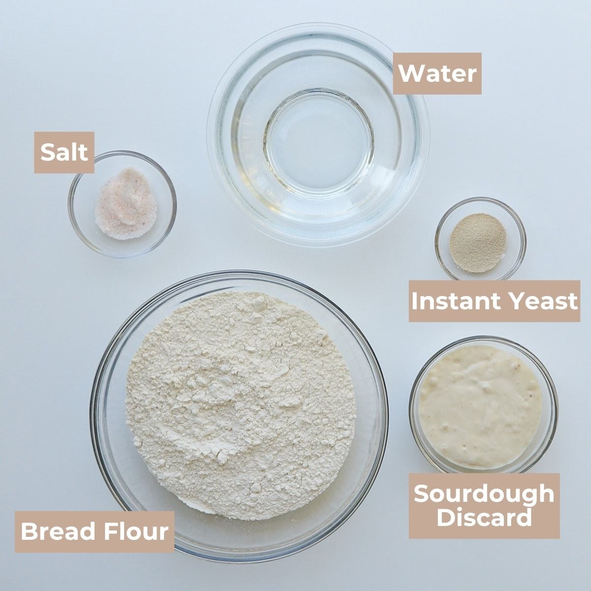 Ingredients in clear bowls for Sourdough Discard Bread.