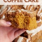A hand holding a slice of sourdough pumpkin coffee cake with a bite taken out of it.