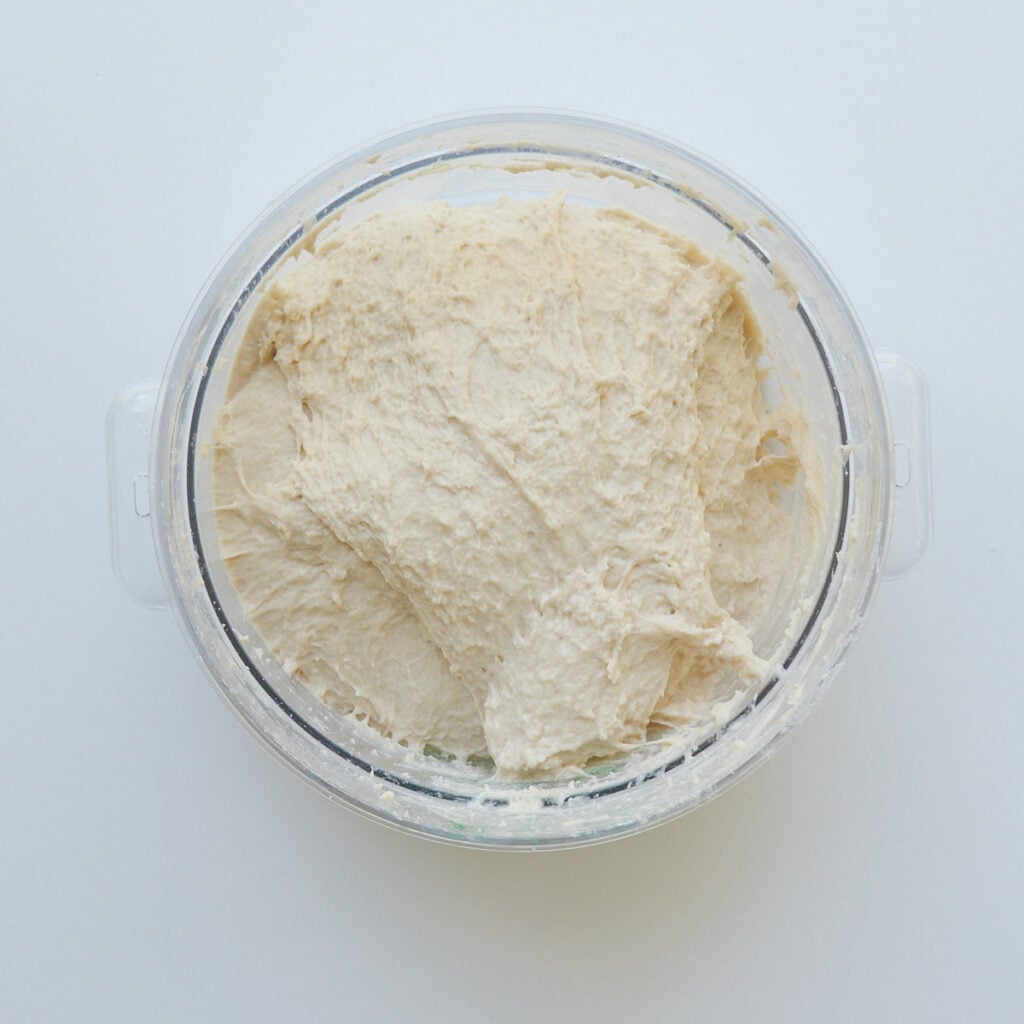 Dough for sourdough discard bread mixed in a clear bowl.