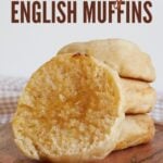 Three Sourdough English Muffins stacked on top of each other with another English Muffin sliced in half.