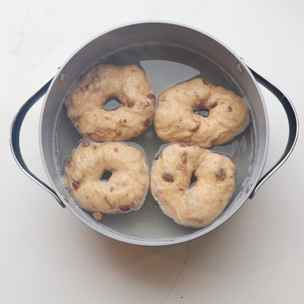 Cinnamon Raisin Sourdough Bagels boiled in a pot with baking soda.